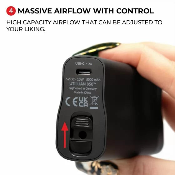 Black utillian 850 device showing the base with air flow control and USB-C port with charging specifications, held by a hand.